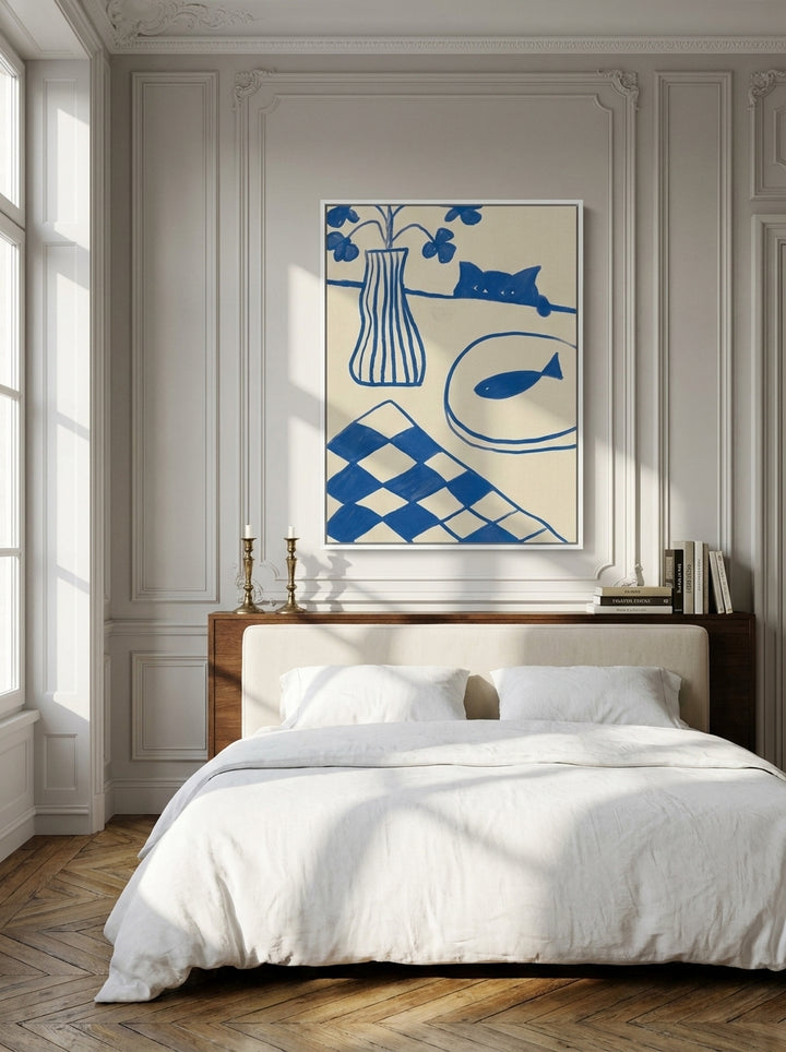 Canvas wall art with a white surround styled on the wall in a Parisian bedroom
