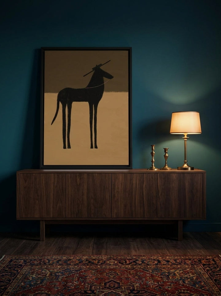 Modern wall art print standing on a sideboard in a moody living room