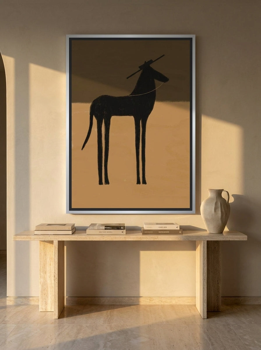 Oversized statement canvas wall art with a silver leaf surround styled on the wall in a luxe living room