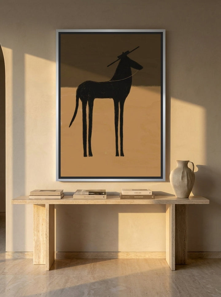 Oversized statement canvas wall art with a silver leaf surround styled on the wall in a luxe living room