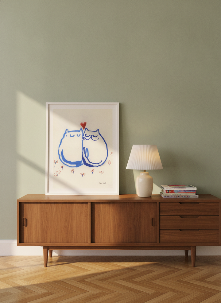 Modern wall art print standing on a sideboard in a mid-century bedroom