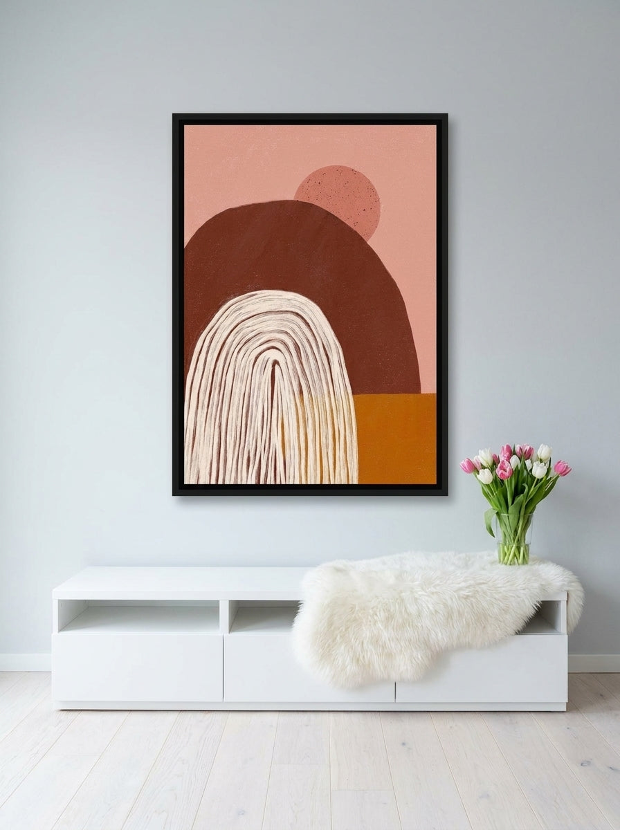 Canvas wall art with a black surround styled on the wall in a bright Scandinavian living room