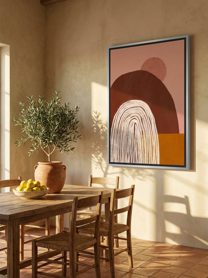Oversized statement canvas wall art with a silver leaf surround styled on the wall in a Mediterranean dining room