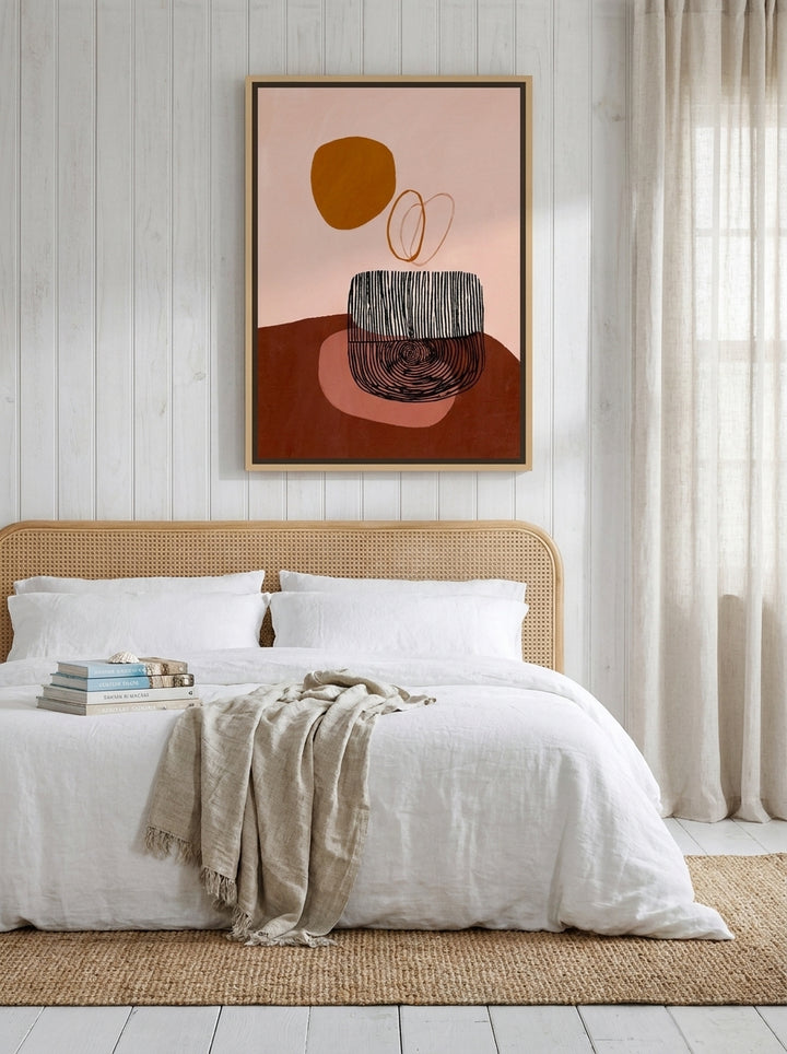 Canvas wall art with a natural timber surround styled on the wall in a coastal bedroom