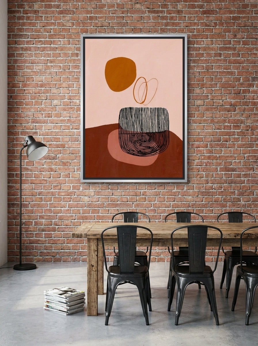 Oversized statement canvas wall art with a silver leaf surround styled on the wall in an industrial loft dining room