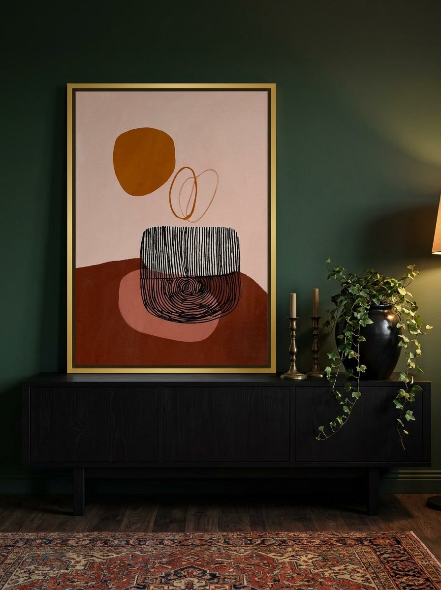 Canvas wall art with a gold leaf surround standing on a console in a moody living room