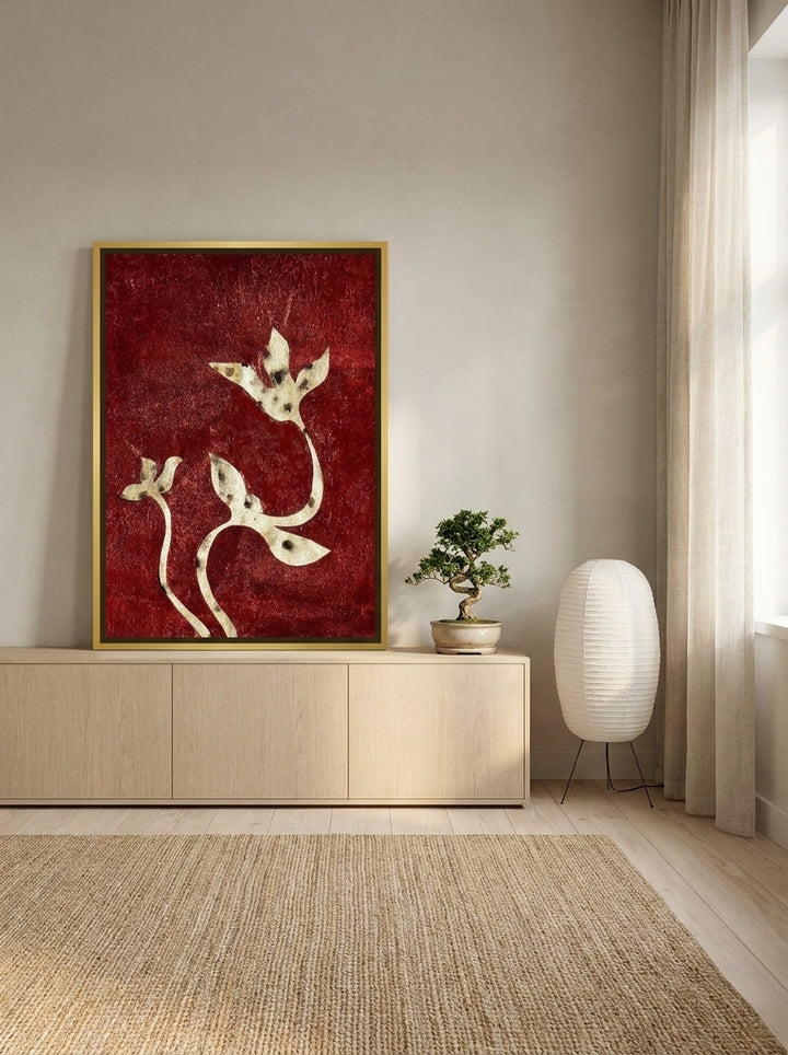 Canvas wall art with a gold leaf surround standing on a sideboard in a warm Japandi living room