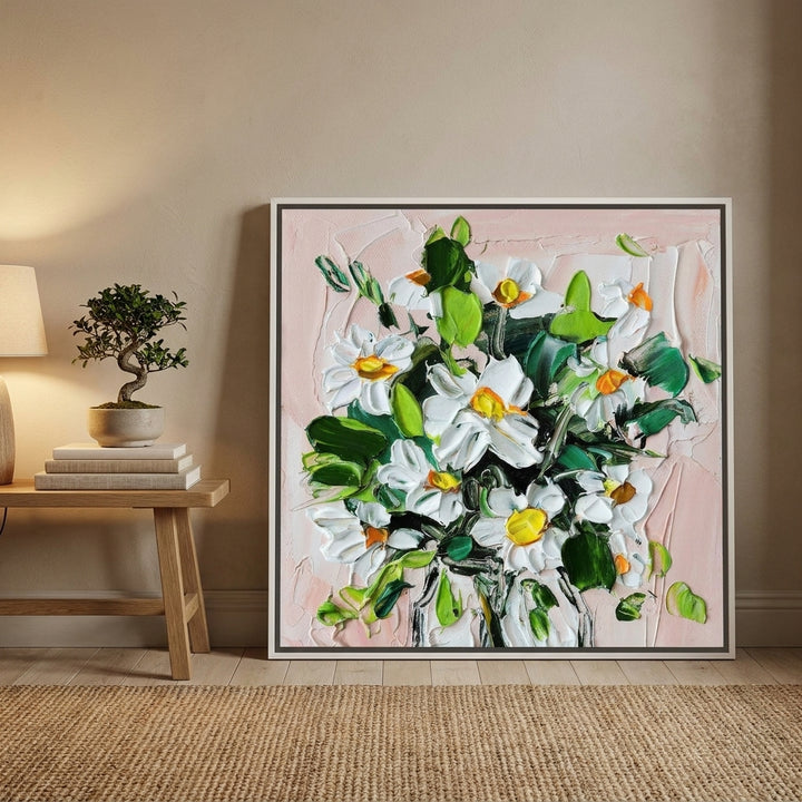 Canvas wall art with a white surround leaning against the wall in a warm Japandi bedroom