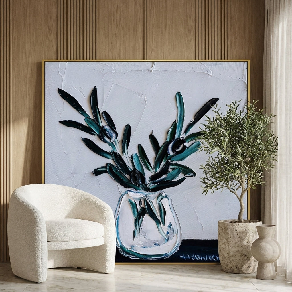 Oversized statement canvas wall art with a gold leaf surround leaning against the wall in a luxe bedroom