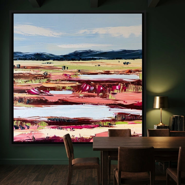 Oversized statement canvas wall art with a black surround styled on the wall in a moody dining room