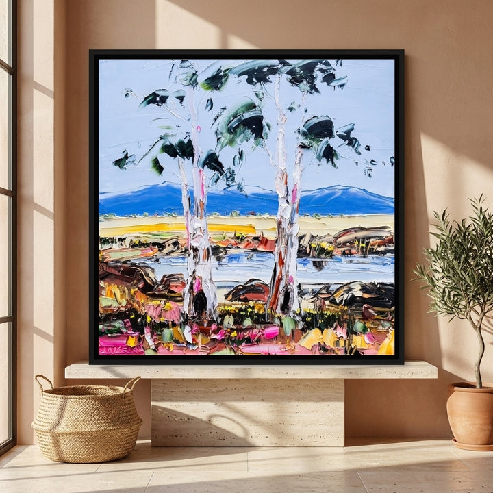Canvas wall art with a black surround standing on a console in a Mediterranean home office
