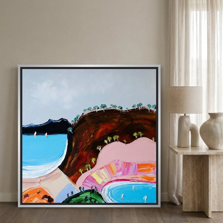 Canvas wall art with a silver leaf surround leaning against the wall in a luxe living room