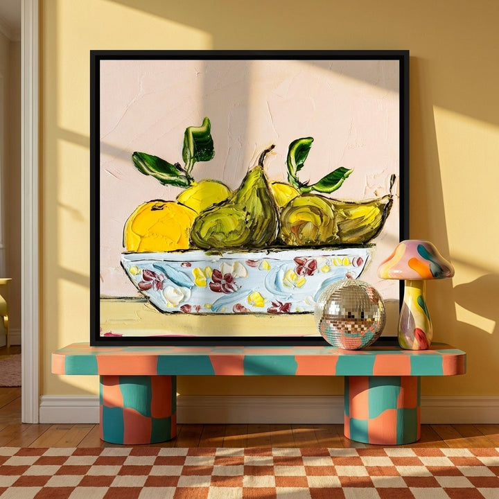 Canvas wall art with a black surround standing on a side table in a colourful eclectic living room