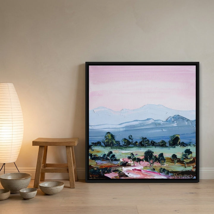 Canvas wall art with a black surround leaning against the wall in a warm Japandi home office