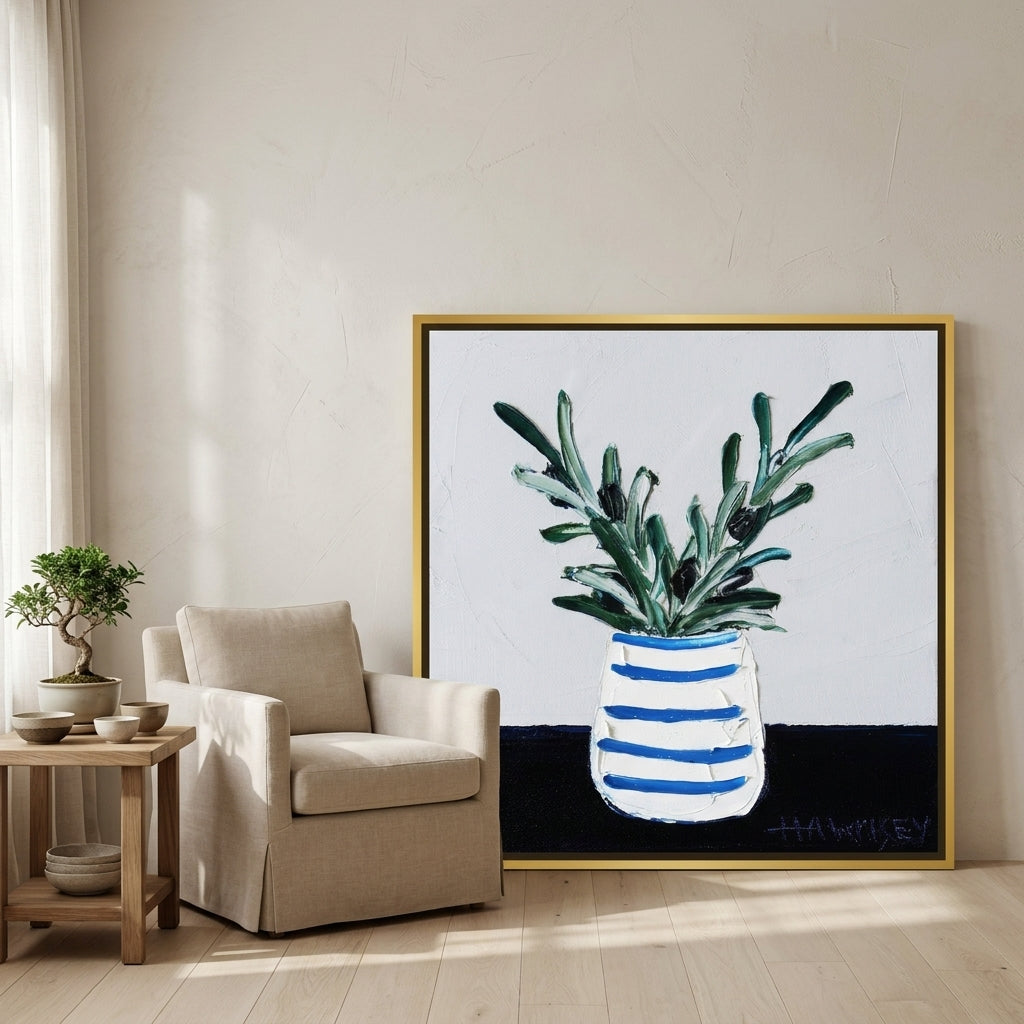 Canvas wall art with a gold leaf surround leaning against the wall in a warm Japandi bathroom