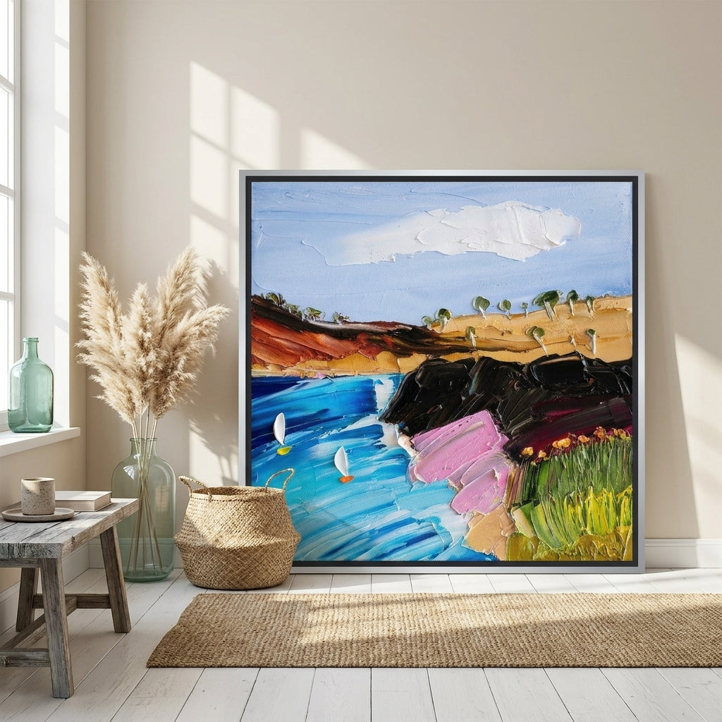 Canvas wall art with a silver leaf surround leaning against the wall in a coastal living room