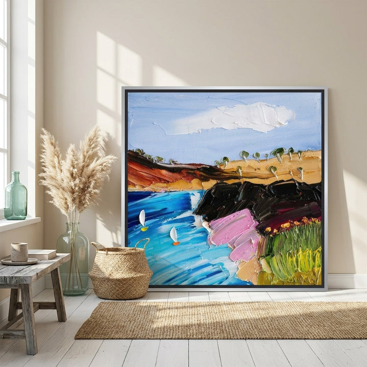 Canvas wall art with a silver leaf surround leaning against the wall in a coastal living room