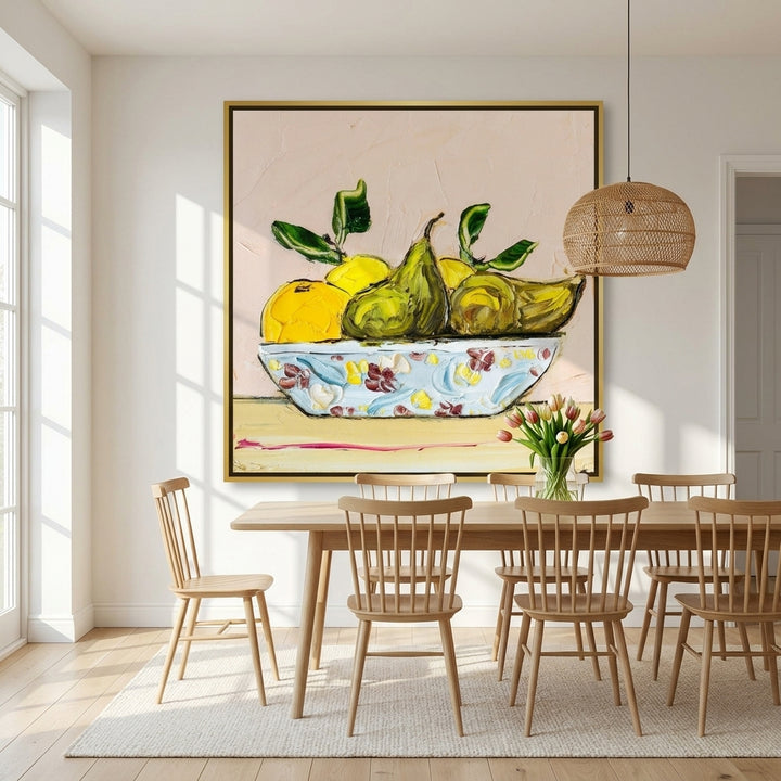 Oversized statement canvas wall art with a gold leaf surround styled on the wall in a bright Scandinavian dining room