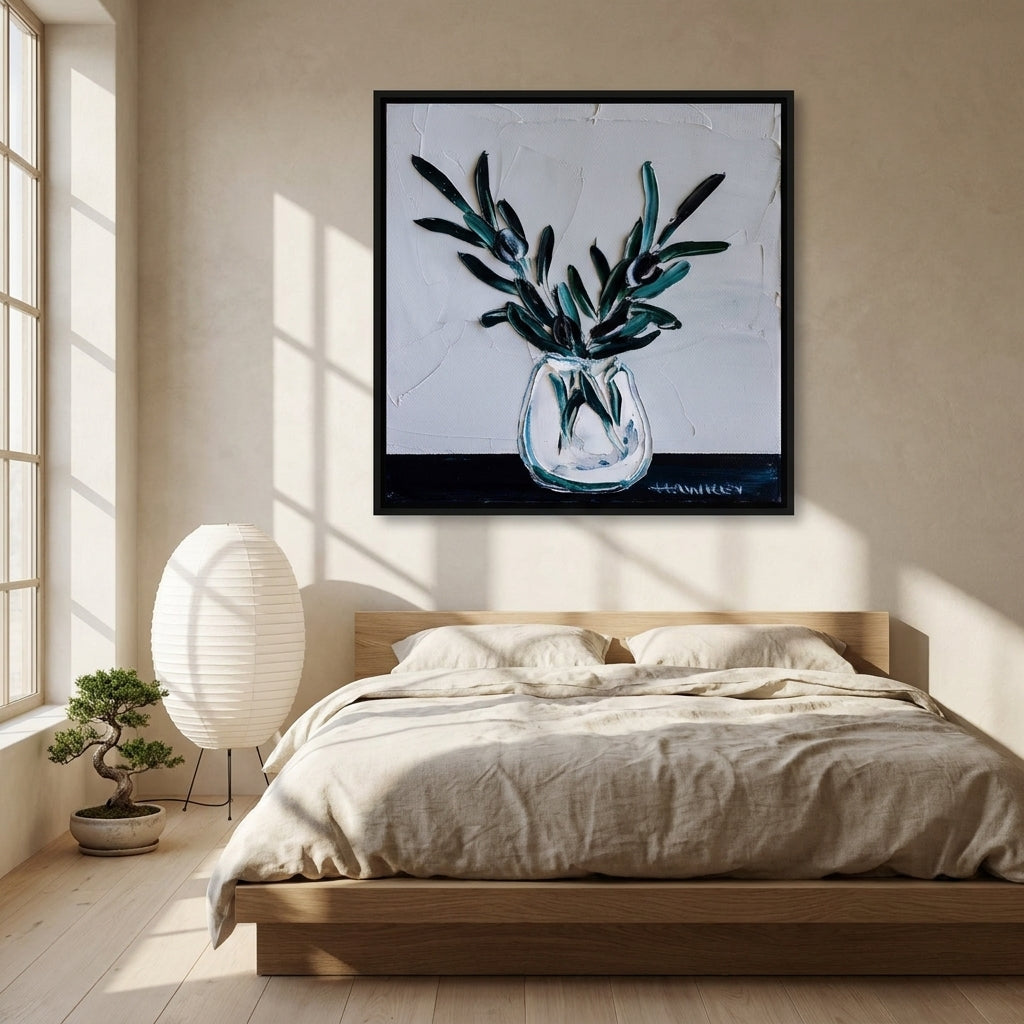 Canvas wall art with a black surround styled on the wall in a warm Japandi bedroom