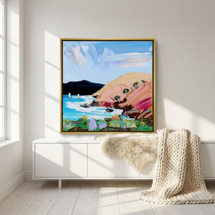 Canvas wall art with a gold leaf surround standing on a sideboard in a bright Scandinavian home office