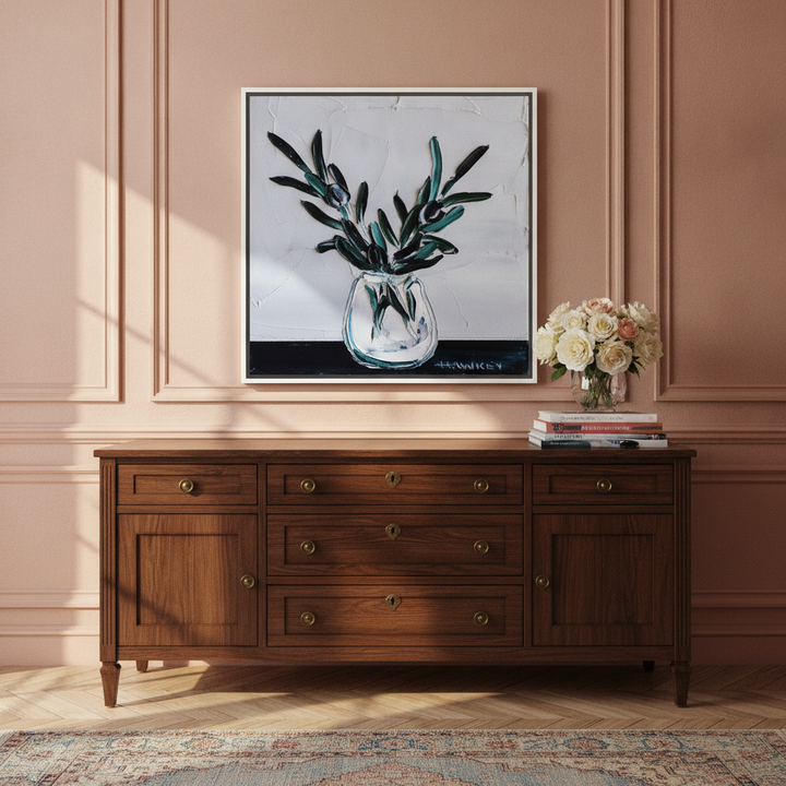 Canvas wall art with a white surround standing on a sideboard in a Parisian home office