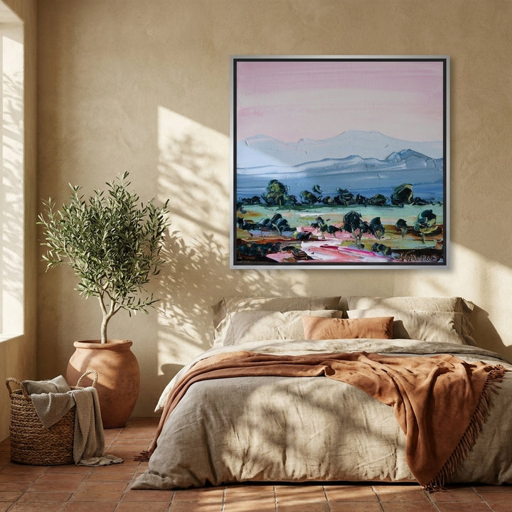 Canvas wall art with a silver leaf surround styled on the wall in a Mediterranean bedroom