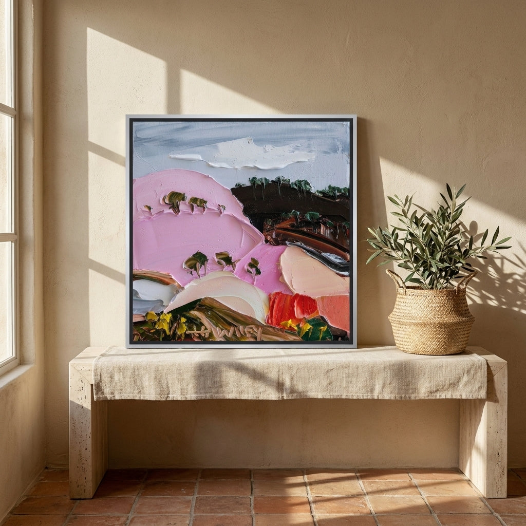 Canvas wall art with a silver leaf surround standing on a console in a Mediterranean living room
