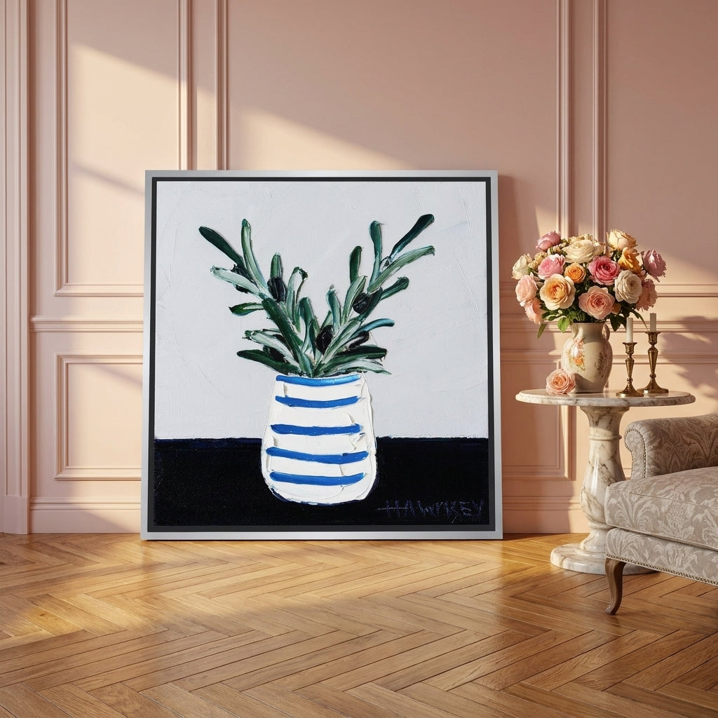 Canvas wall art with a silver leaf surround leaning against the wall in a Parisian kitchen