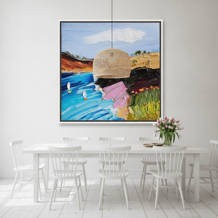 Oversized statement canvas wall art with a white surround styled on the wall in a bright Scandinavian dining room
