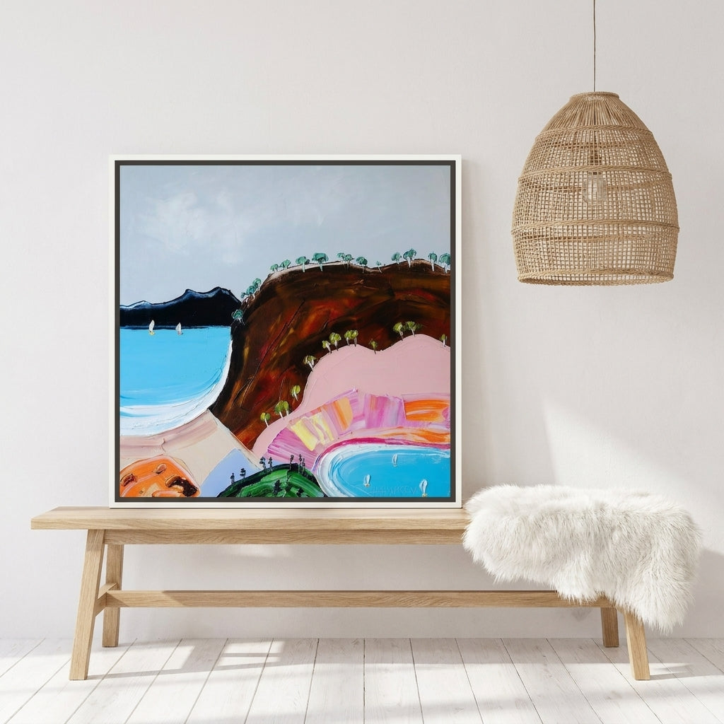 Canvas wall art with a white surround standing on a bench in a bright Scandinavian home office