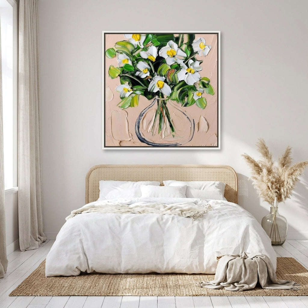 Canvas wall art with a white surround styled on the wall in a coastal bedroom