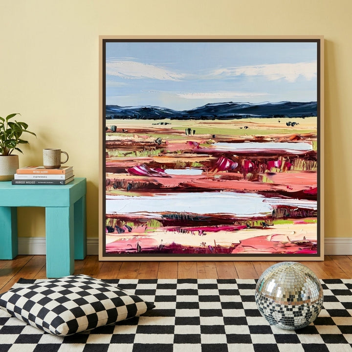 Canvas wall art with a natural timber surround standing on a side table in a colourful eclectic home office