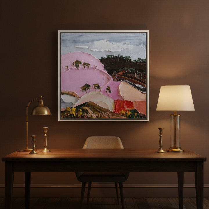 Canvas wall art with a white surround styled on the wall in a moody home office