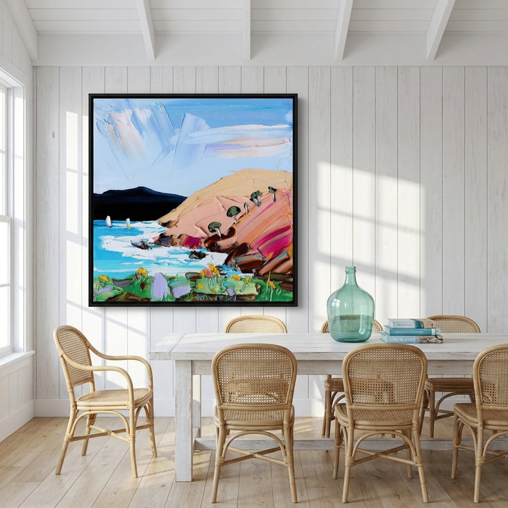 Oversized statement canvas wall art with a black surround styled on the wall in a coastal dining room