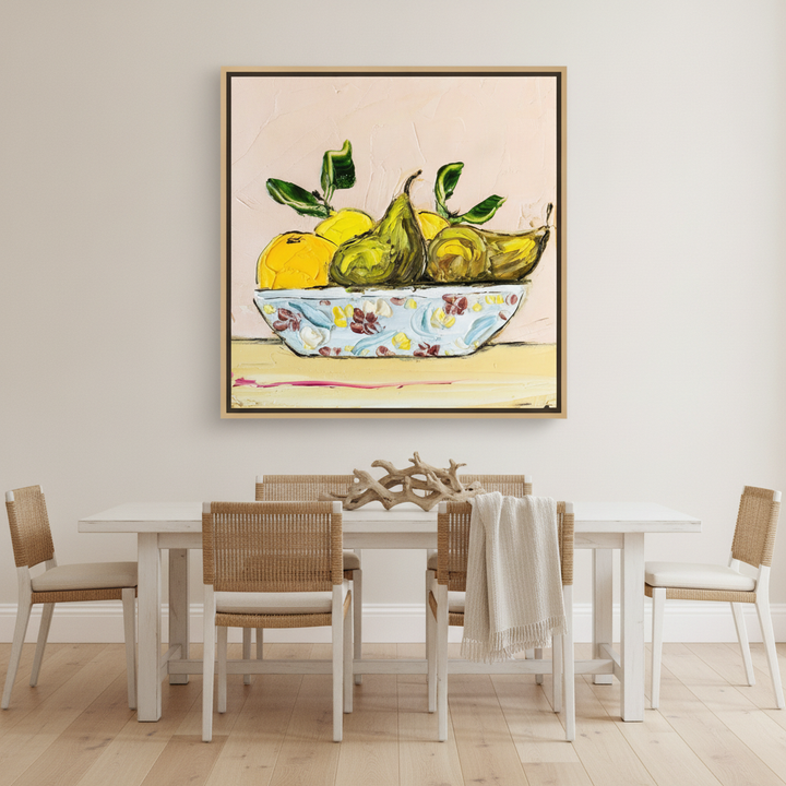 Oversized statement canvas wall art with a natural timber surround styled on the wall in a coastal dining room