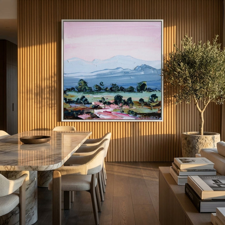 Oversized statement canvas wall art with a white surround styled on the wall in a luxe dining room