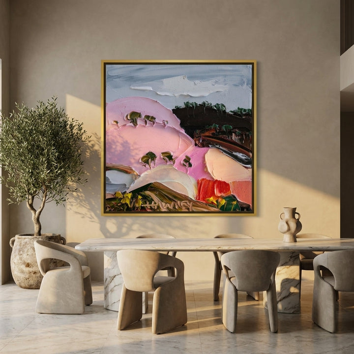Oversized statement canvas wall art with a gold leaf surround styled on the wall in a luxe dining room