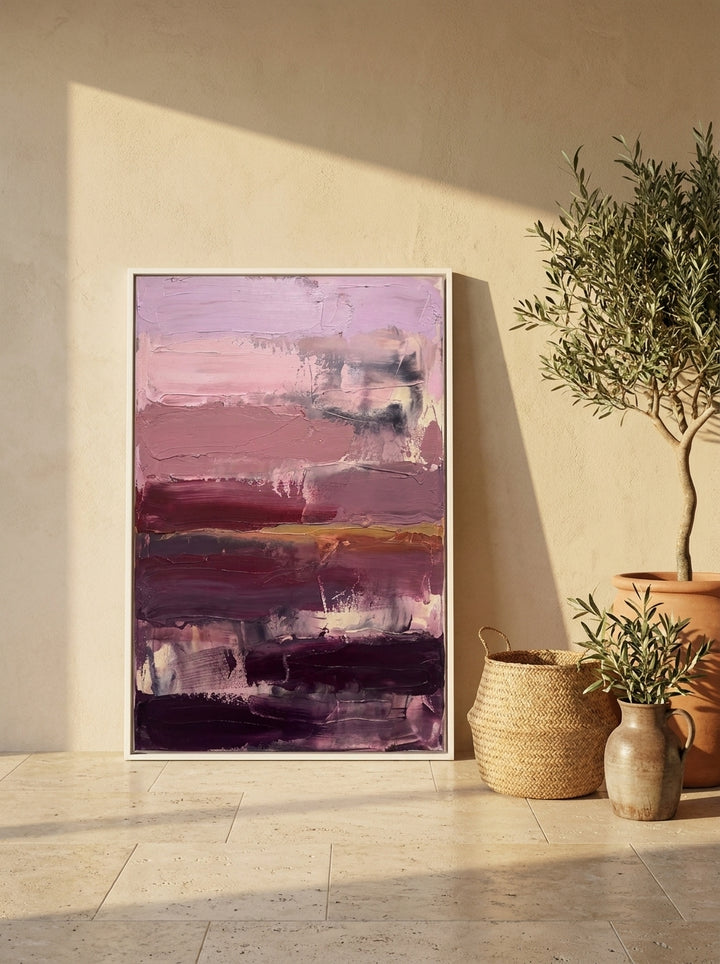 Oversized statement canvas wall art with a white surround leaning against the wall in a Mediterranean dining room
