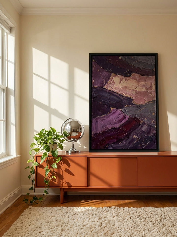 Canvas wall art with a black surround standing on a sideboard in a retro 70s living room