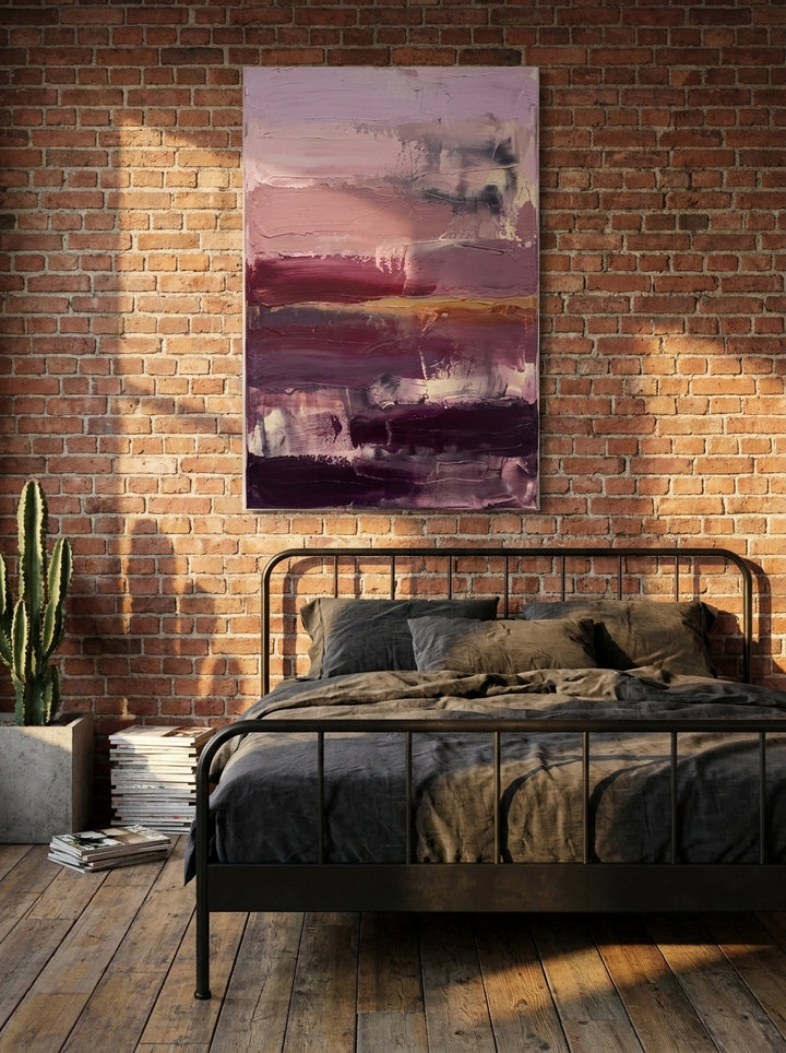 Stretched canvas wall art styled on the wall in an industrial loft bedroom