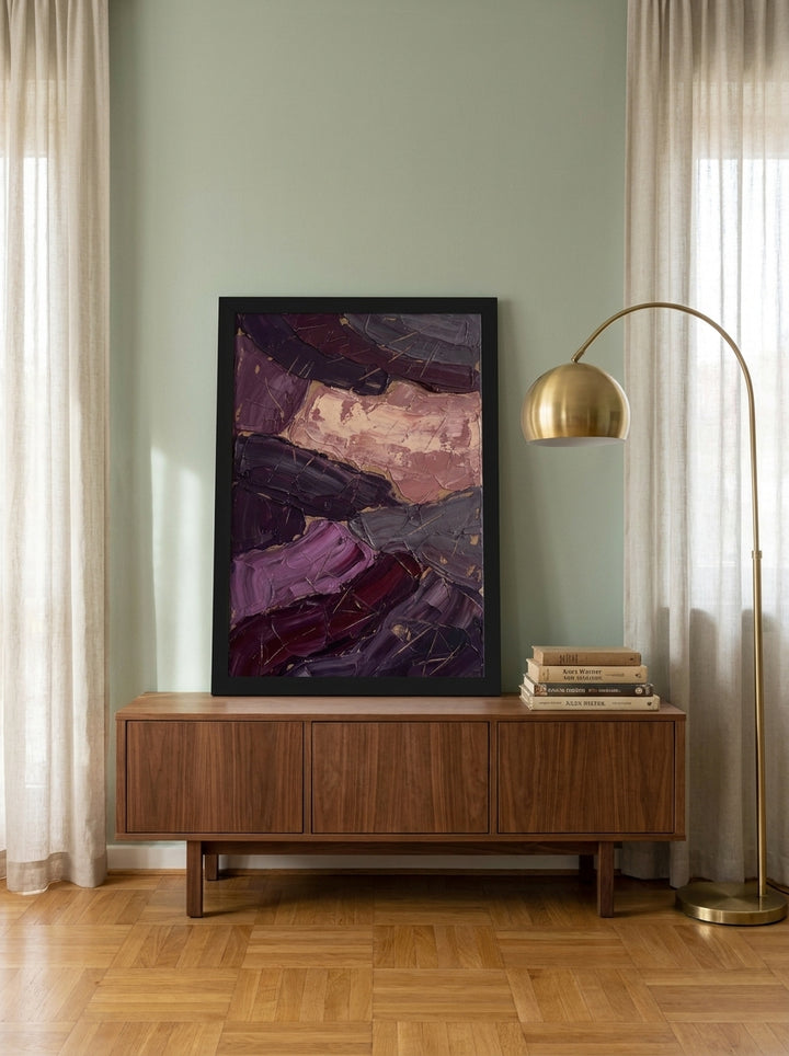 Modern wall art print standing on a sideboard in a mid-century living room