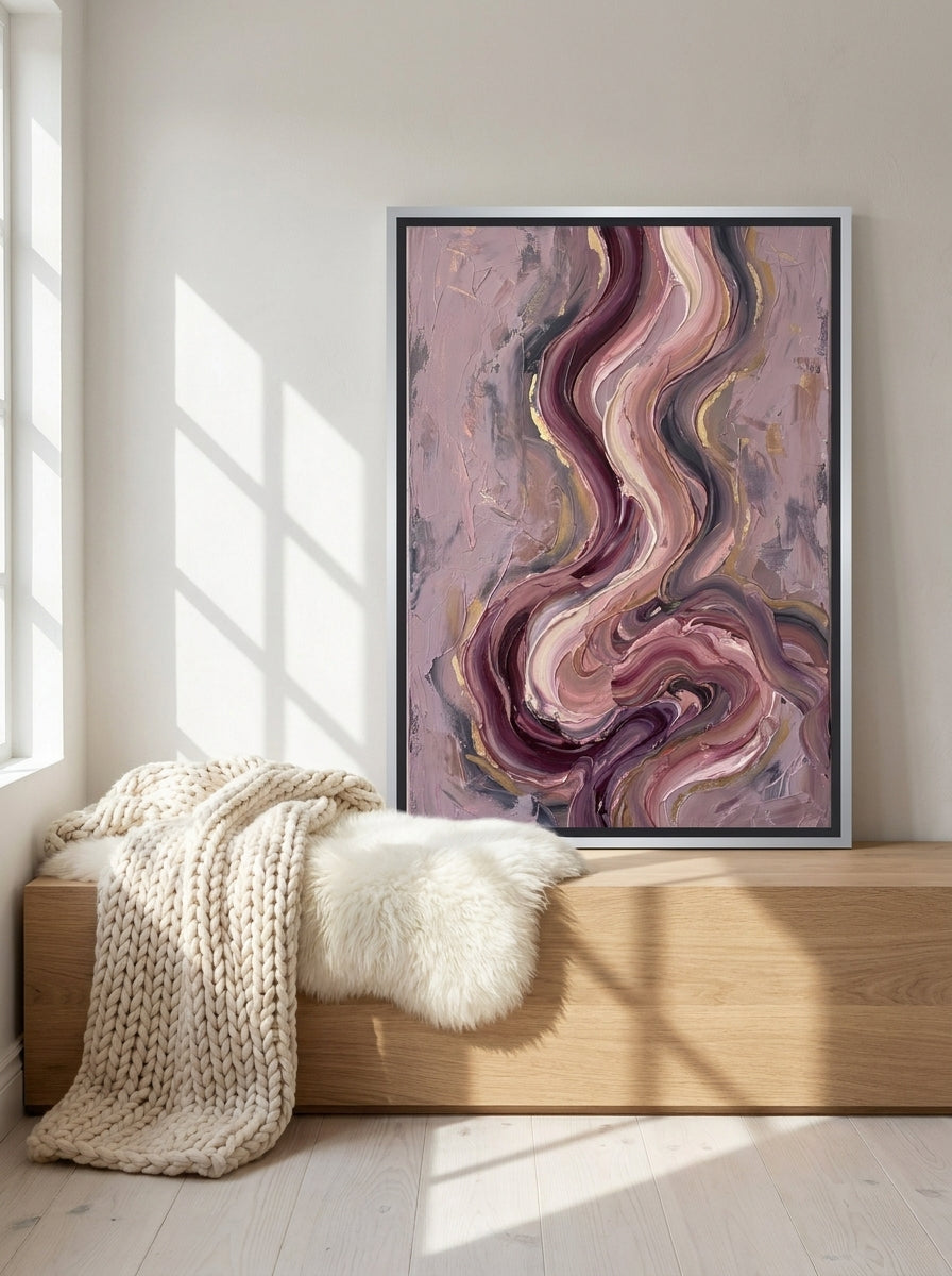 Canvas wall art with a silver leaf surround standing on a bench in a bright Scandinavian bedroom
