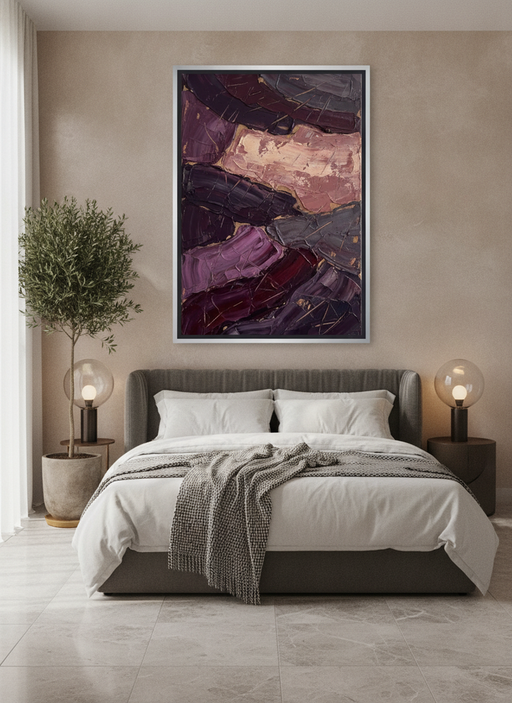 Oversized statement canvas wall art with a silver leaf surround styled on the wall in a luxe bedroom