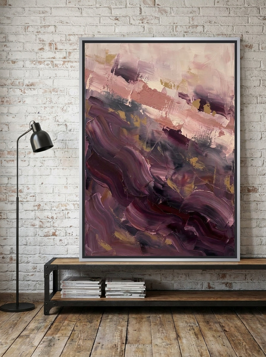Canvas wall art with a silver leaf surround standing on a console in an industrial loft bedroom