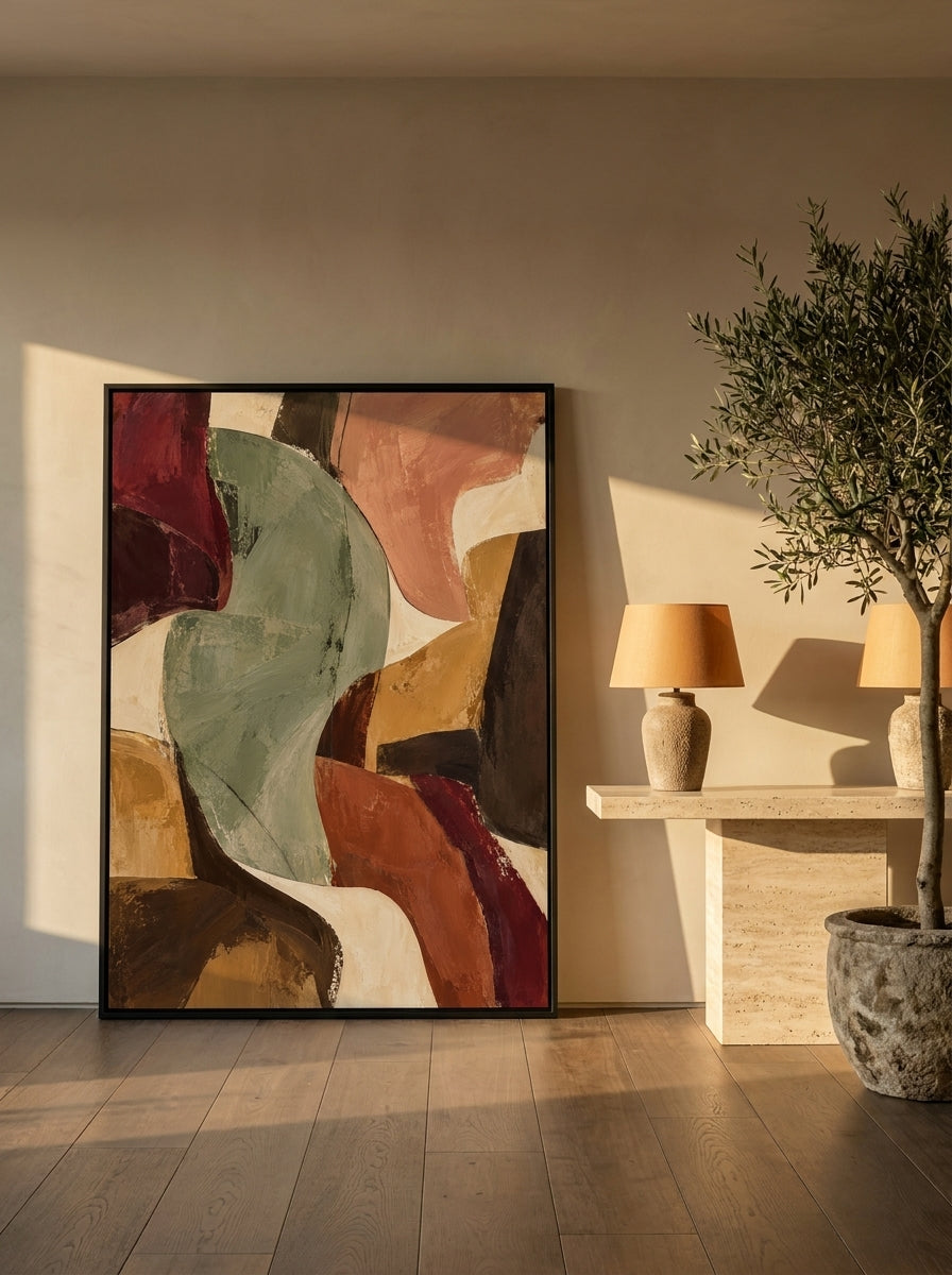 Canvas wall art with a black surround leaning against the wall in a luxe dining room