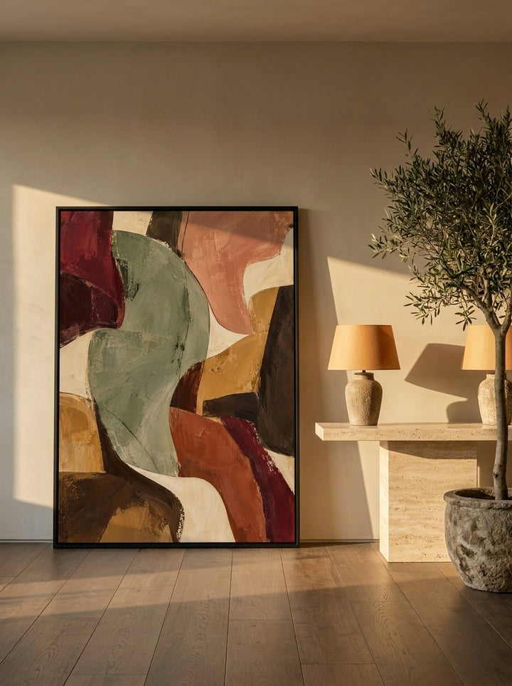 Canvas wall art with a black surround leaning against the wall in a luxe dining room