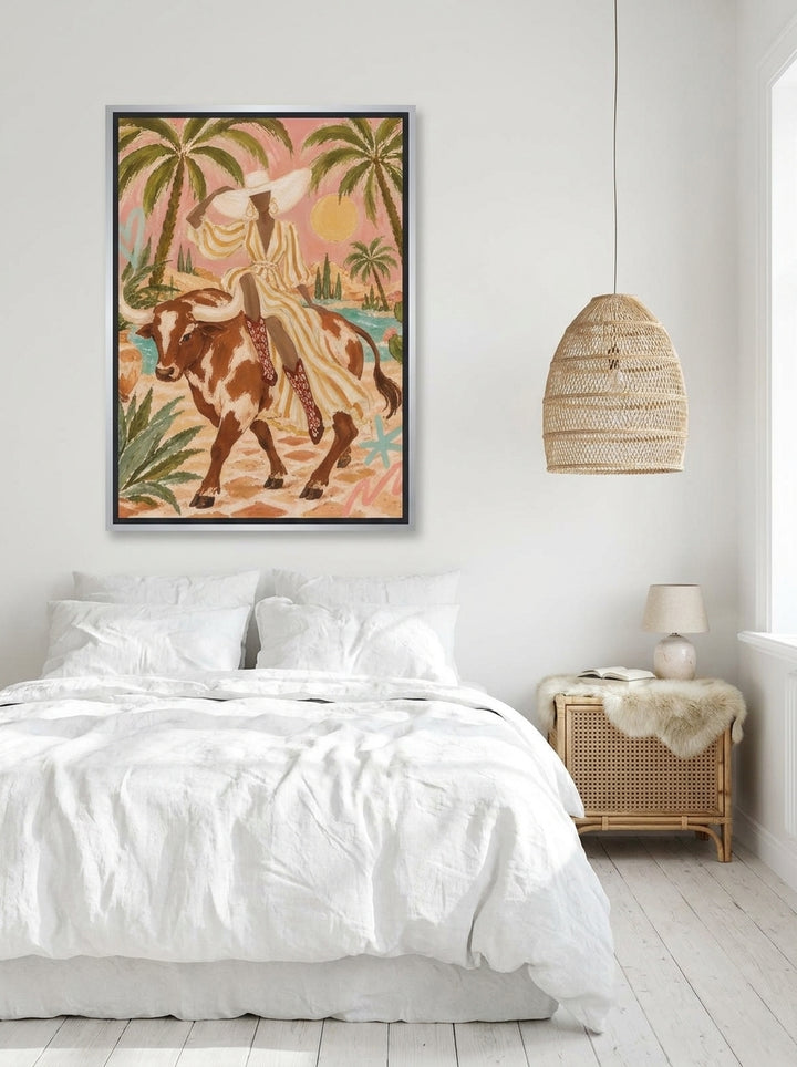 Canvas wall art with a silver leaf surround styled on the wall in a bright Scandinavian bedroom