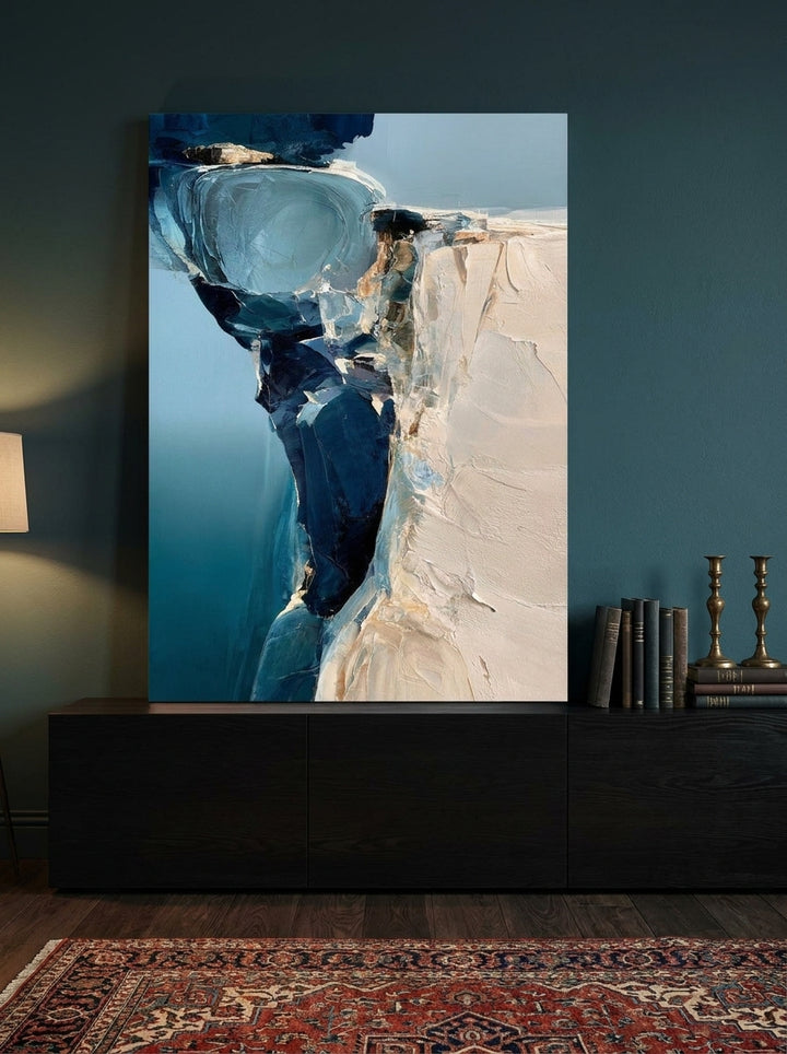 Stretched canvas wall art standing on a console in a moody home office