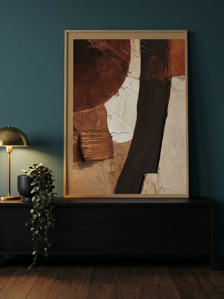 Modern wall art print standing on a console in a moody bedroom