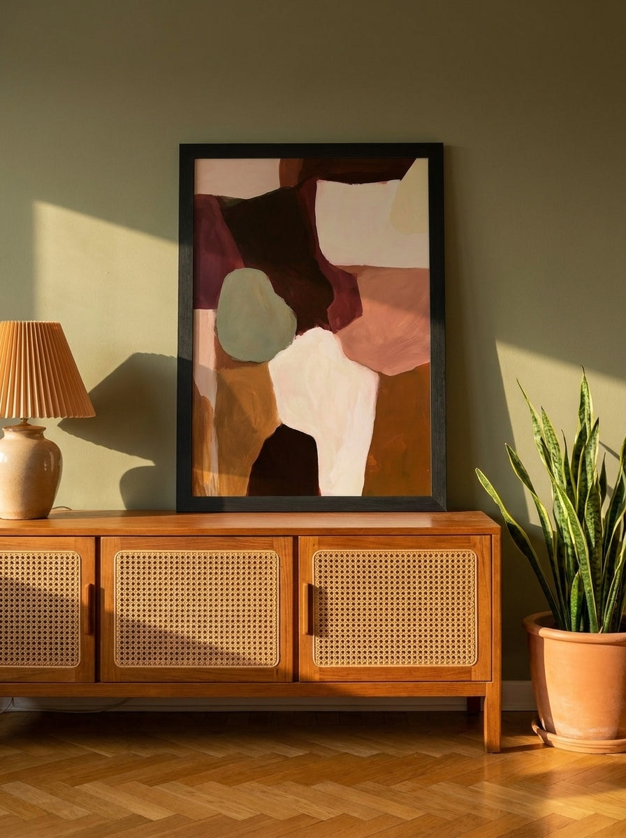 Modern wall art print standing on a sideboard in a mid-century home office